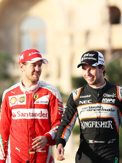 (L to R): Sebastian Vettel, Ferrari with Sergio Perez, Sahara Force India F1