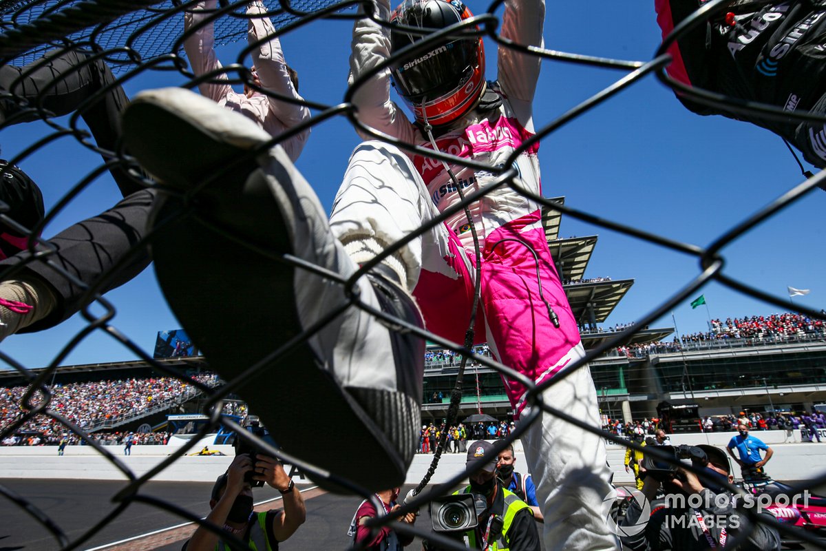Helio Castroneves, Meyer Shank Racing Honda, Climbs the Fence in front of the crowd, Mike Shank