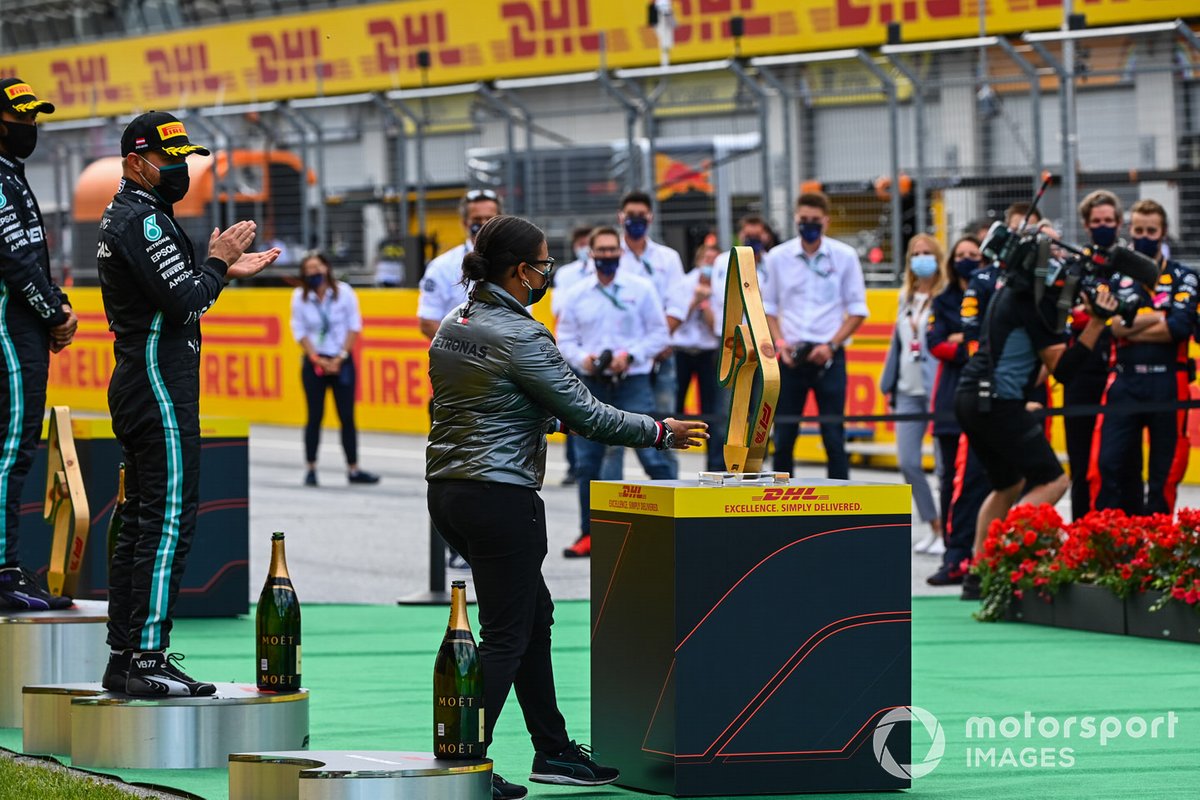 Valtteri Bottas, Mercedes-AMG Petronas F1, applauds a colleague on the podium as Lewis Hamilton, Mercedes-AMG Petronas F1 looks on