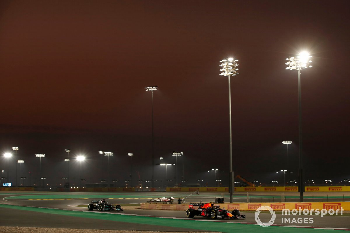 Sergio Perez, Red Bull Racing RB16B, leads Sir Lewis Hamilton, Mercedes W12