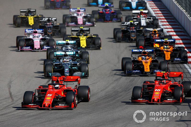Sebastian Vettel, Ferrari SF90, leads Charles Leclerc, Ferrari SF90, Lewis Hamilton, Mercedes AMG F1 W10, Carlos Sainz Jr., McLaren MCL34, Valtteri Bottas, Mercedes AMG W10, and the rest of the field at the start of the race
