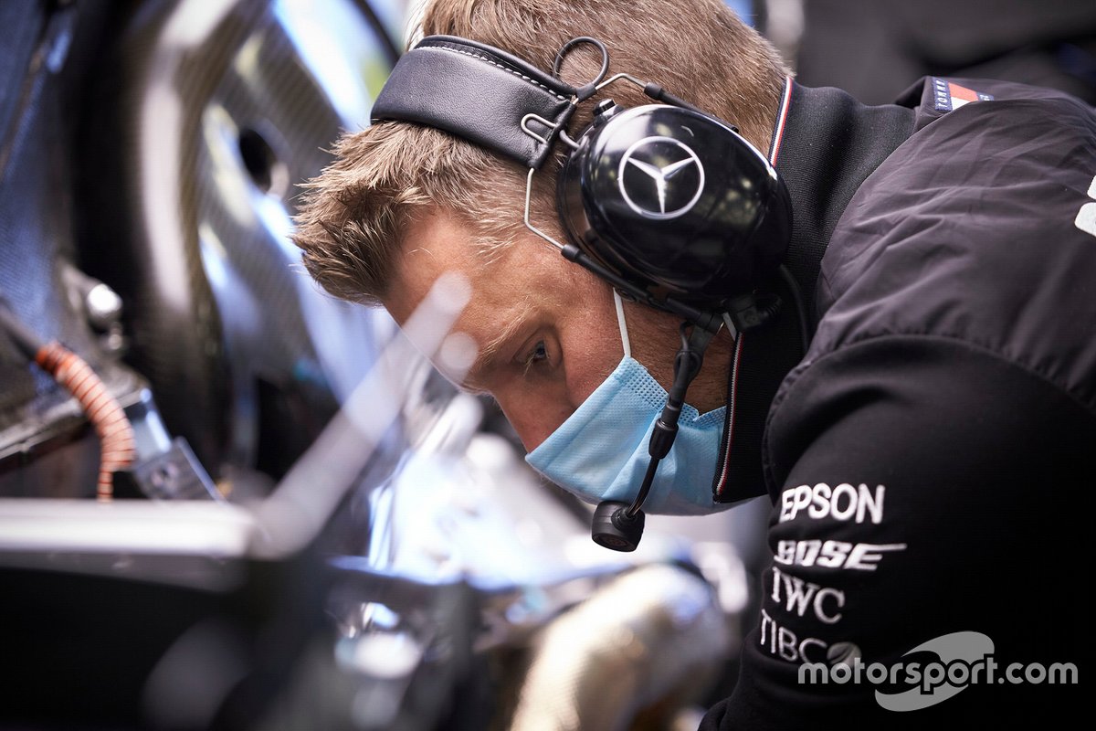 Een Mercedes-monteur met een mondkapje op.