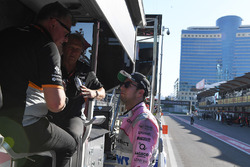 Sergio Perez, Sahara Force India talks, Robert Fearnley, Sahara Force India F1 Team Deputy Team Principal and Otmar Szafnauer, Sahara Force India Formula One Team Chief Operating Officer on the pit wall gantry following his pit stop, a broken front wing