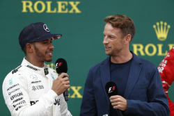 Race winner Lewis Hamilton, Mercedes AMG F1, is interviewed by Jenson Button, McLaren, on the podium