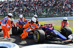 Race retiree Carlos Sainz Jr., Scuderia Toro Rosso STR12 is pushed by Marshals