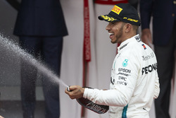 Lewis Hamilton, Mercedes AMG F1, sprays Champagne on the podium