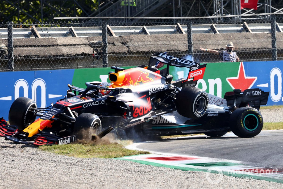 Max Verstappen, Red Bull Racing RB16B, and Lewis Hamilton, Mercedes W12, collide whilst battling for position
