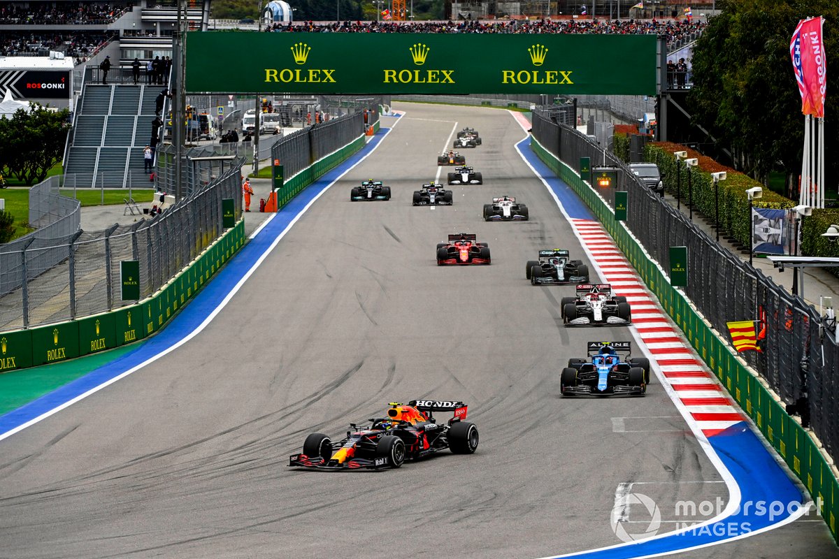 Sergio Perez, Red Bull Racing RB16B, Esteban Ocon, Alpine A521, and Kimi Raikkonen, Alfa Romeo Racing C41