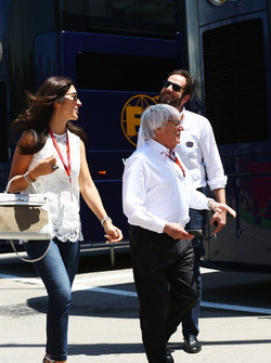 Bernie Ecclestone with his wife Fabiana Flosi, passing Matteo Bonciani, FIA Media Delegate