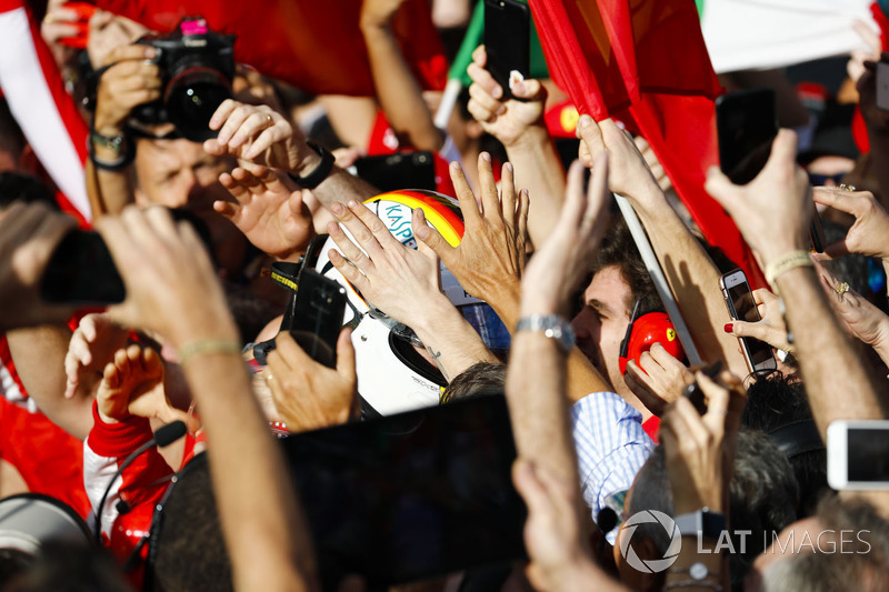 Race winner Sebastian Vettel, Ferrari, celebrates on arrival in Parc Ferme with his team
