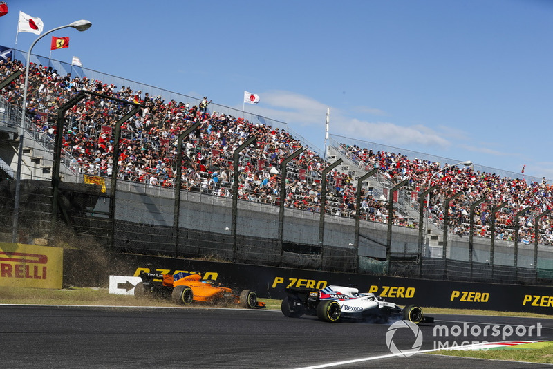 Fernando Alonso, McLaren MCL33, runs off the track behind Lance Stroll, Williams FW41