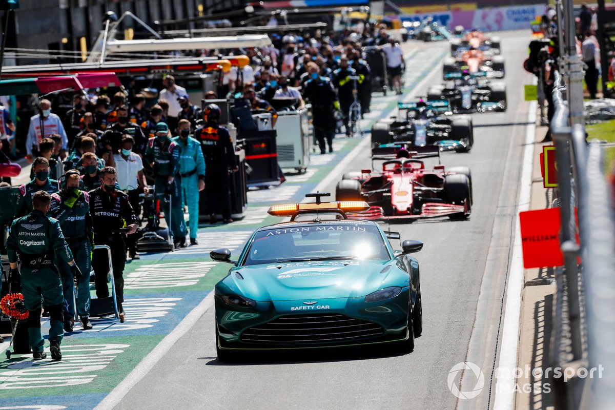 The Safety Car Charles Leclerc, Ferrari SF21, Lewis Hamilton, Mercedes W12, and the rest of the field through the pit lane