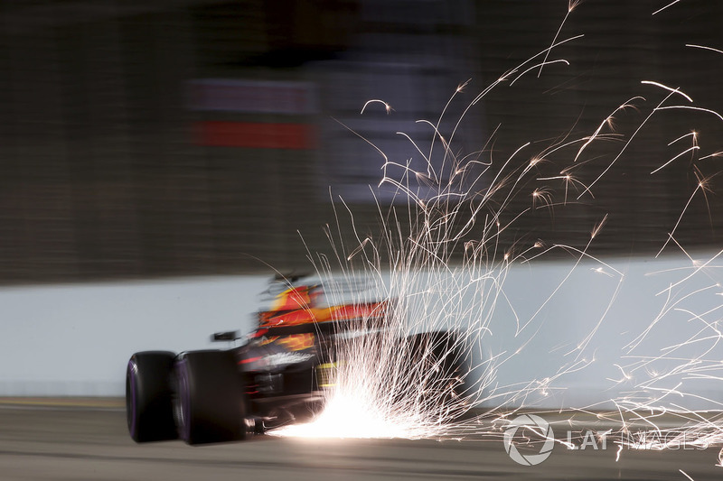 Sparks pour from the rear of Daniel Ricciardo, Red Bull Racing RB13