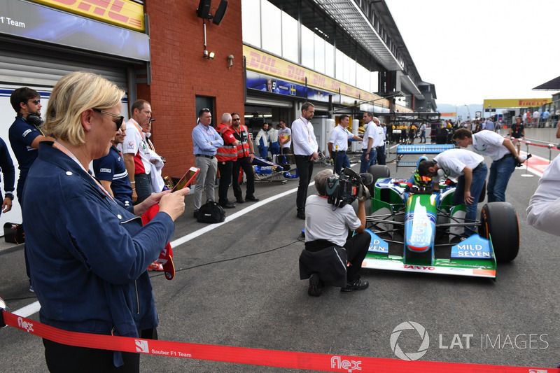 Sabine Kehm, takes a photo of Mick Schumacher, Benetton B194