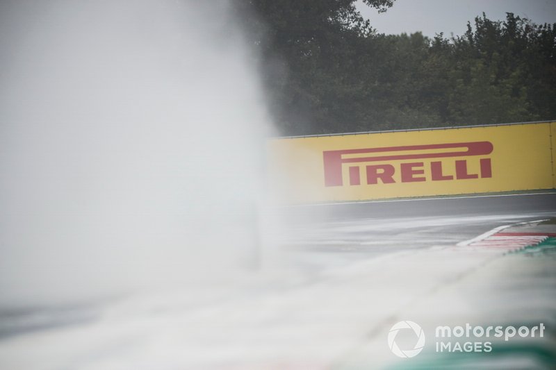 Cement dust which was laid down to cover a heavy oil spill in the F2 race prior to the session fills the air