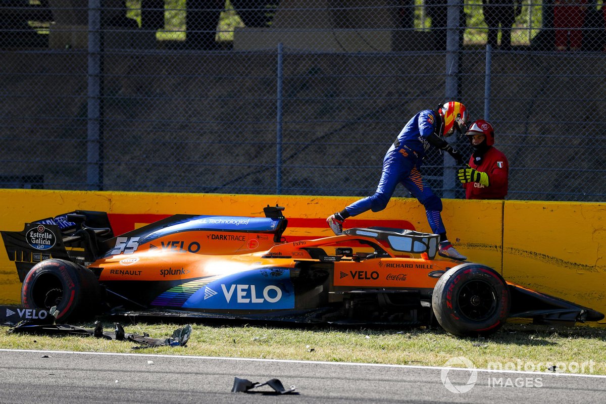 Carlos Sainz Jr., McLaren, climbs out of his damaged car after crashing out