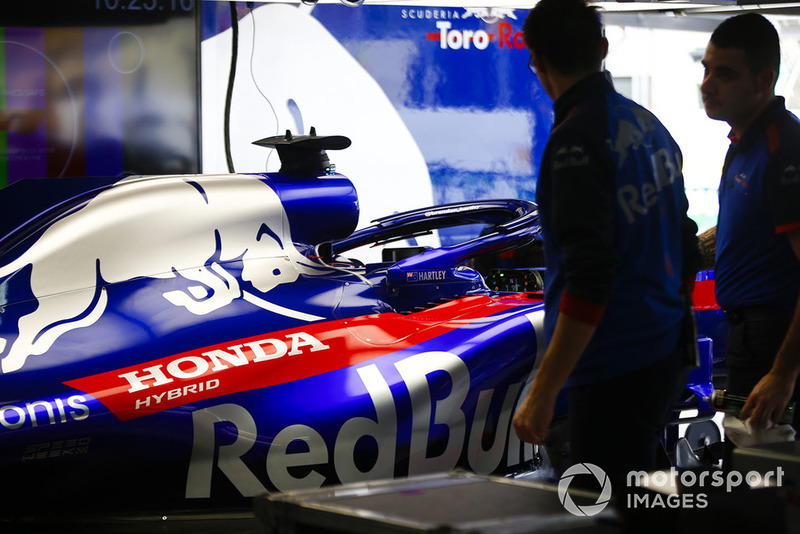 Toro Rosso Honda mechanics work in the garage next to the Brendon Hartley Toro Rosso STR13