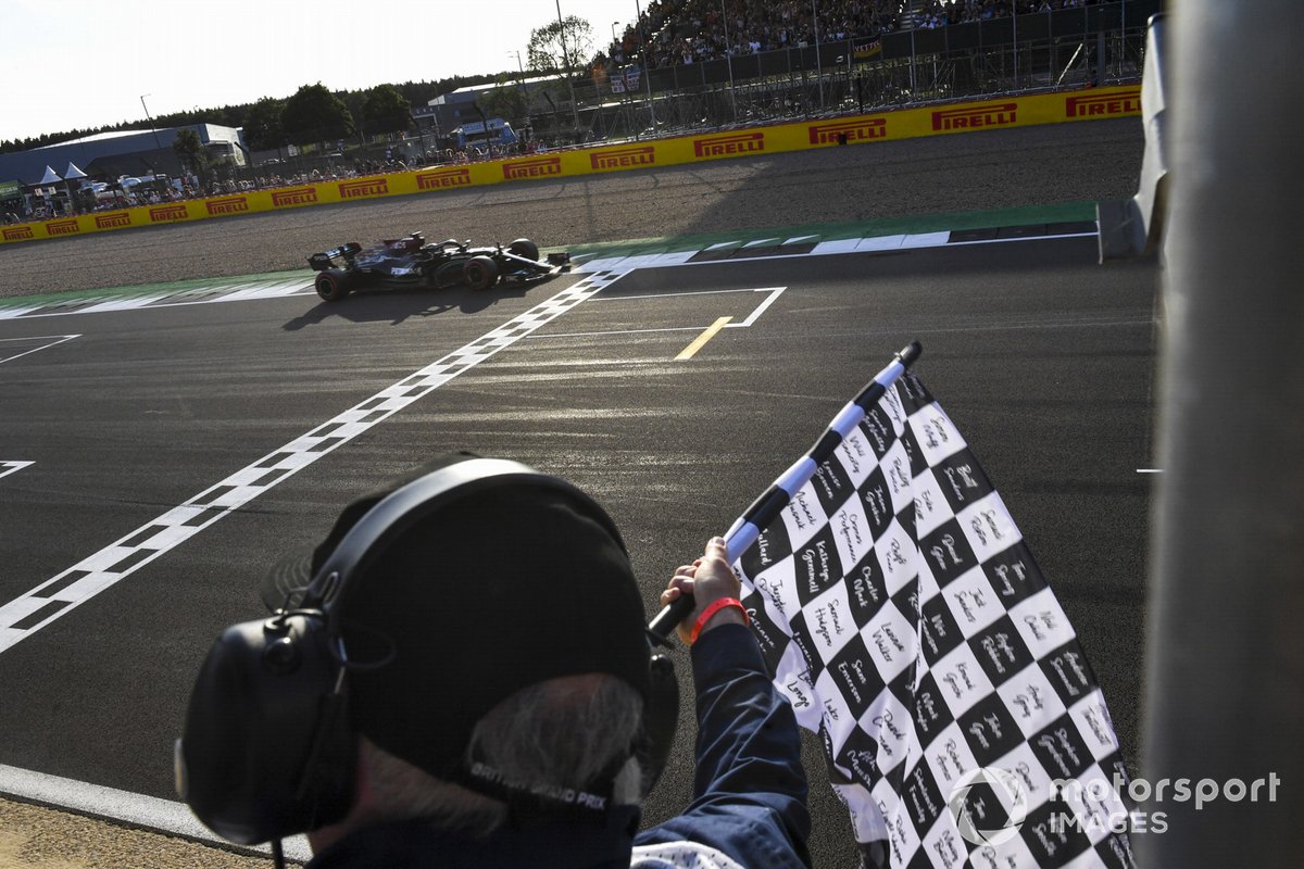 Lewis Hamilton, Mercedes W12, passes the chequered flag to take pole at the end of Qualifying