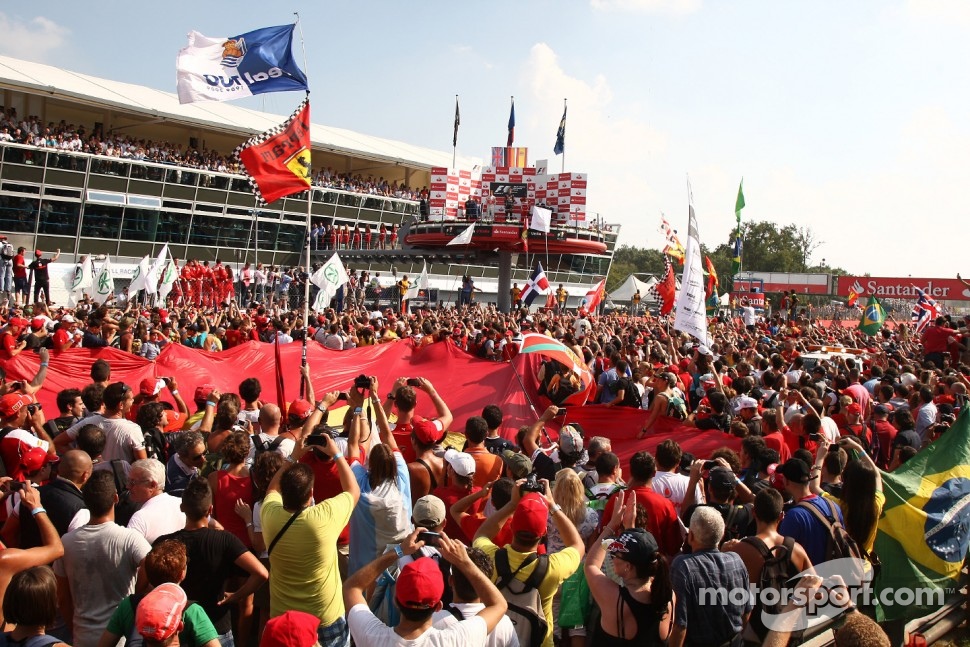 Fans on the track enjoy the podium