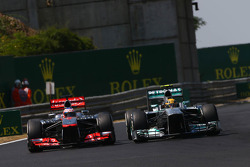 Jenson Button, McLaren MP4-28 and Lewis Hamilton, Mercedes AMG F1 W04 battle for position