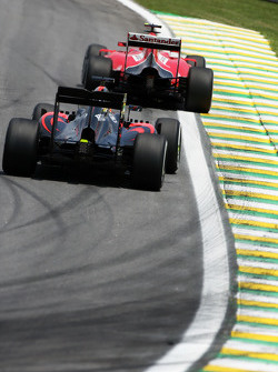 Kimi Raikkonen, Ferrari SF15-T leads Fernando Alonso, McLaren MP4-30