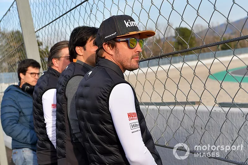 Fernando Alonso watches the action trackside