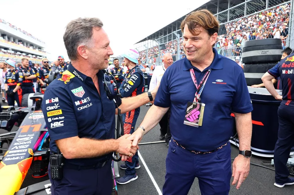 Red Bull Racing Team Principal Christian Horner shakes hands with Jim Farley, CEO of Ford on the grid