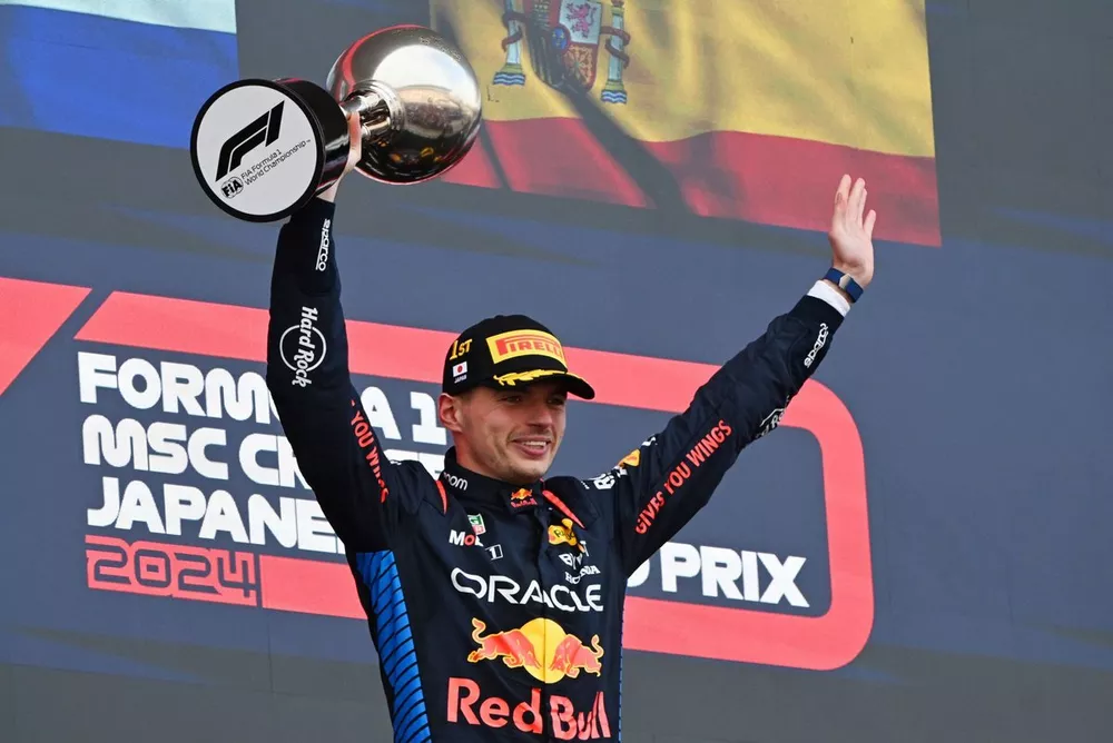 Max Verstappen, Red Bull Racing, 1st position, lifts the trophy in celebration 