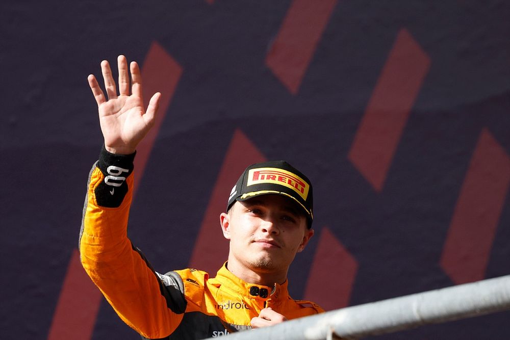 Lando Norris, McLaren, 3rd position, waves as he arrives on the podium