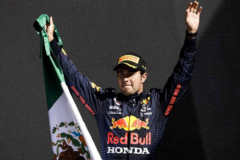 Sergio Perez, Red Bull Racing, 3rd position, on the podium with a Mexican flag