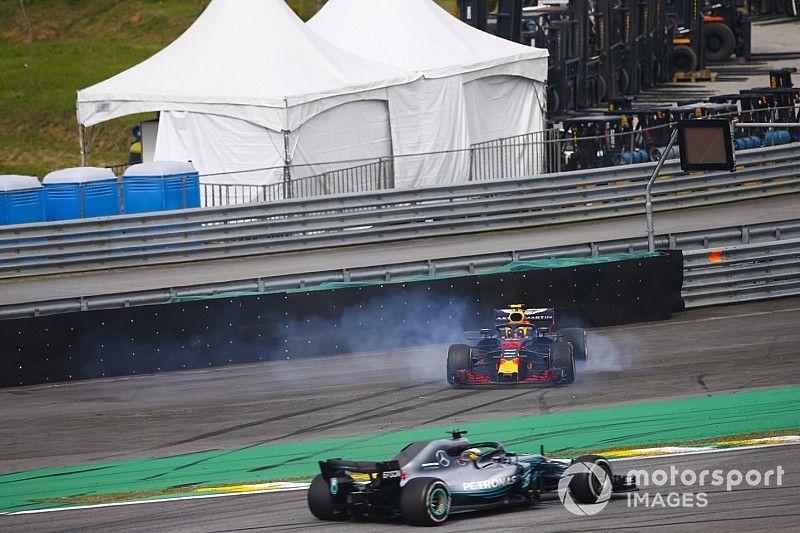 Lewis Hamilton, Mercedes AMG F1 W09, passes a spinning Max Verstappen, Red Bull Racing RB14 Tag Heuer, after the latter suffers a collision with Esteban Ocon, Force India VJM11 Mercedes. 