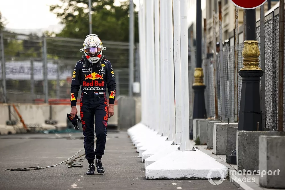 Max Verstappen, Red Bull Racing walking with his head down after retiring from the race