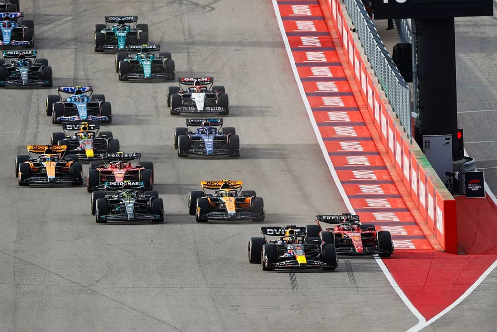 Max Verstappen, Red Bull Racing RB19, squeezes Charles Leclerc, Ferrari SF-23, ahead of Lando Norris, McLaren MCL60, Lewis Hamilton, Mercedes F1 W14, the rest of the field