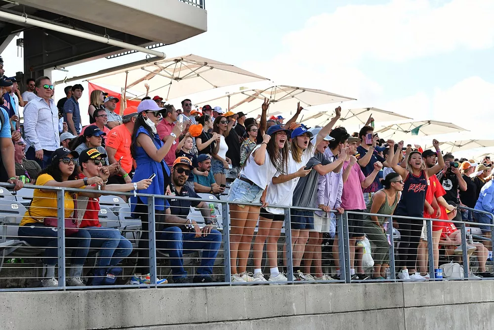 Fans cheer from a grandstand