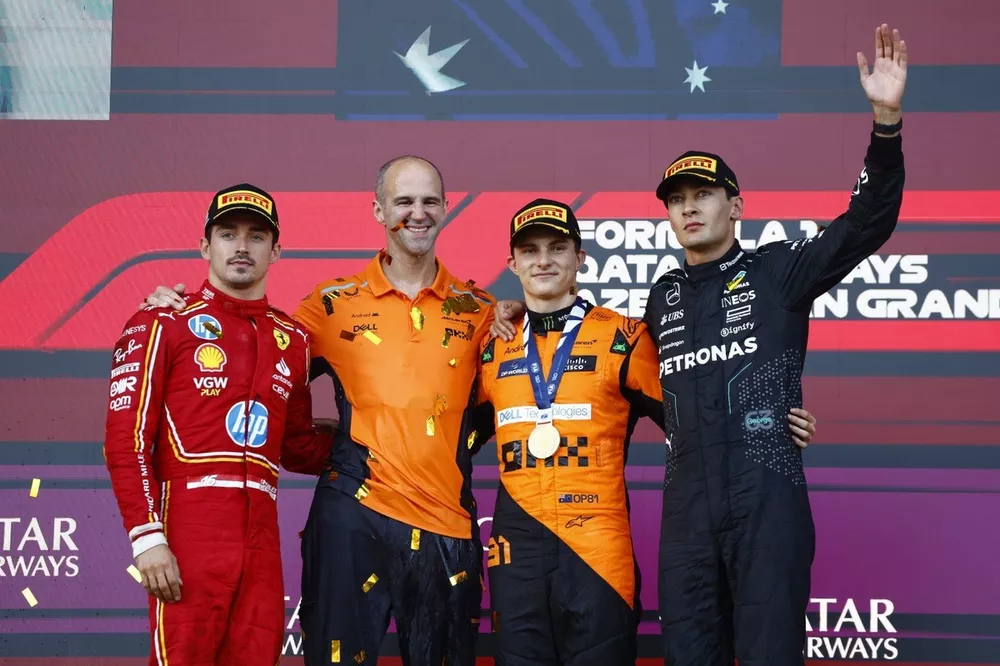 Charles Leclerc, Scuderia Ferrari, 2nd position, the McLaren trophy delegate, Oscar Piastri, McLaren F1 Team, 1st position, George Russell, Mercedes-AMG F1 Team, 3rd position