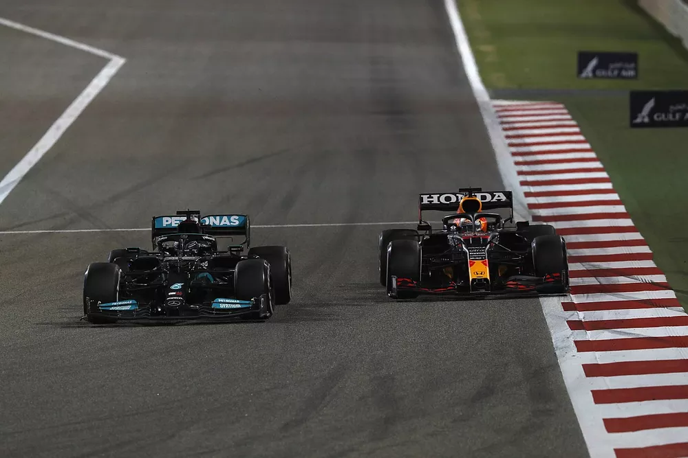 Lewis Hamilton, Mercedes W12, passes Max Verstappen, Red Bull Racing RB16B