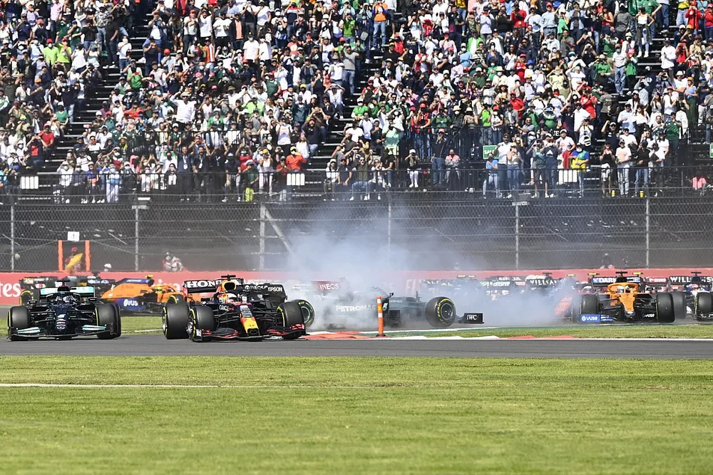 Max Verstappen, Red Bull Racing RB16B, Lewis Hamilton, Mercedes W12, as Valtteri Bottas, Mercedes W12, spins on the opening lap