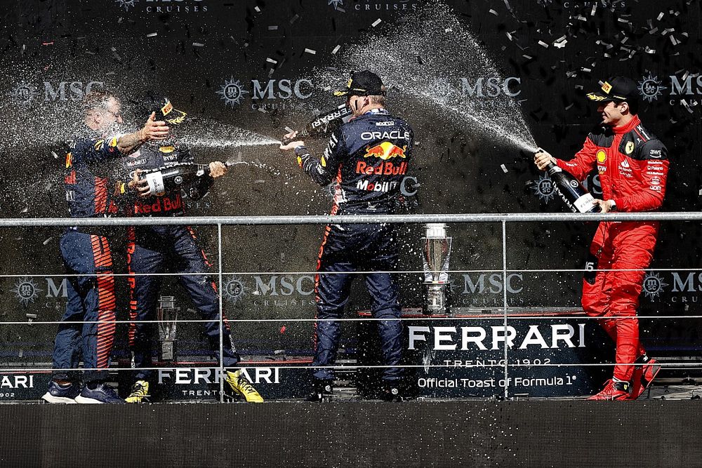 The Red Bull trophy delegate, Sergio Perez, Red Bull Racing, 2nd position, Max Verstappen, Red Bull Racing, 1st position, Charles Leclerc, Scuderia Ferrari, 3rd position, celebrate on the podium with Champagne