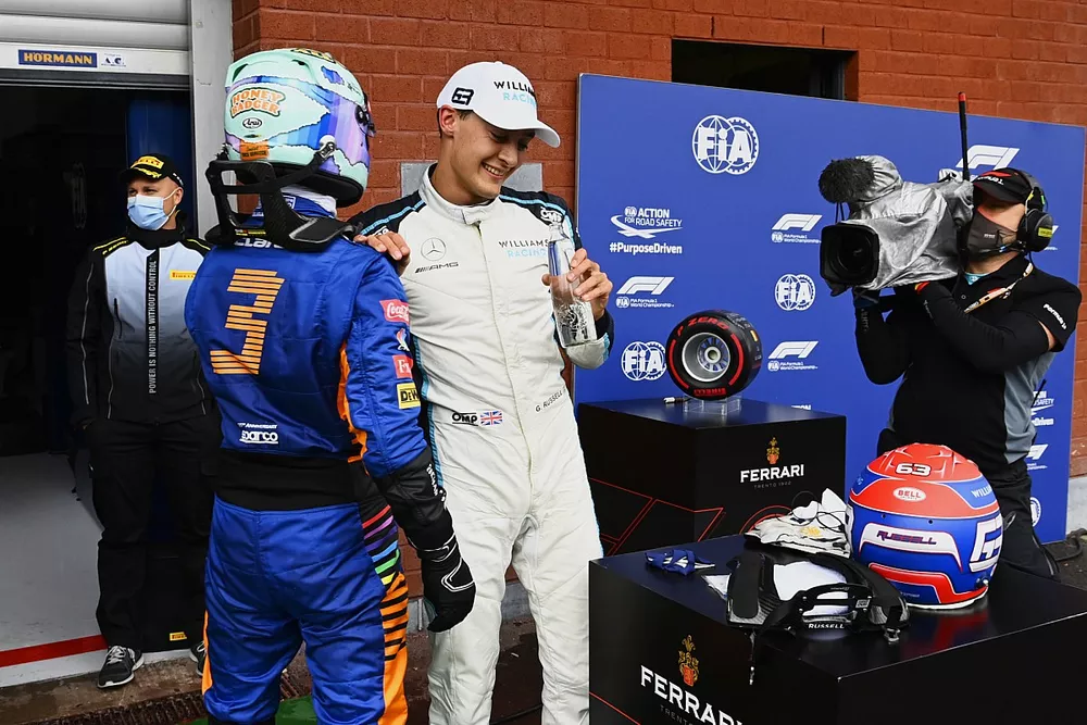 Daniel Ricciardo, McLaren, and George Russell, Williams, talk in Parc Ferme after Qualifying