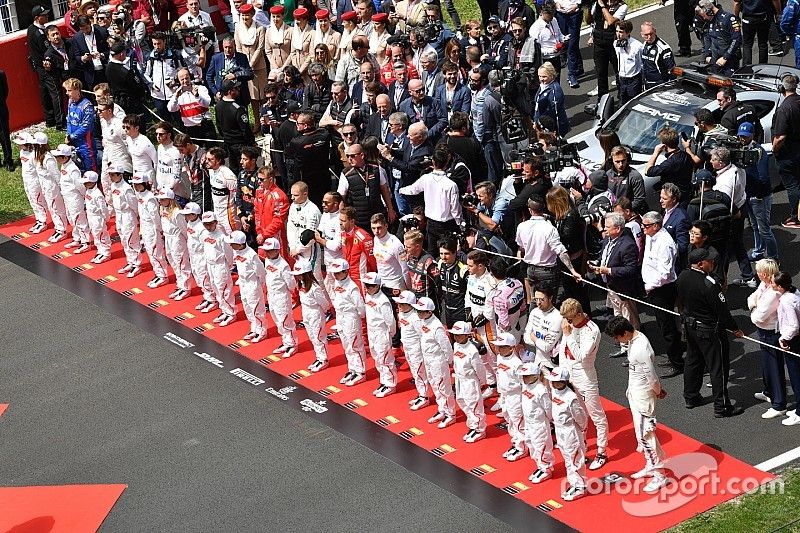 Los pilotos observan el himno nacional en la grilla