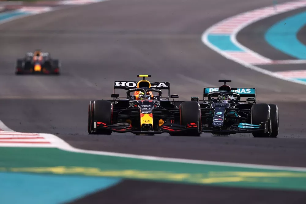 Sergio Perez, Red Bull Racing RB16B, Lewis Hamilton, Mercedes W12 battle for track position with Max Verstappen, Red Bull Racing RB16B