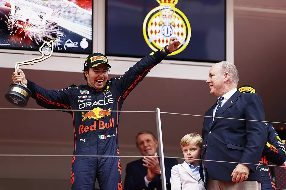 Sergio Perez, Red Bull Racing, 1st position, celebrates on the podium with his trophy