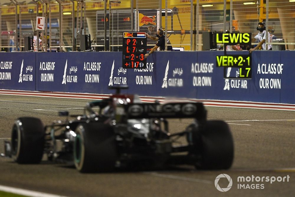 Lewis Hamilton, Mercedes W12, passes a pit board
