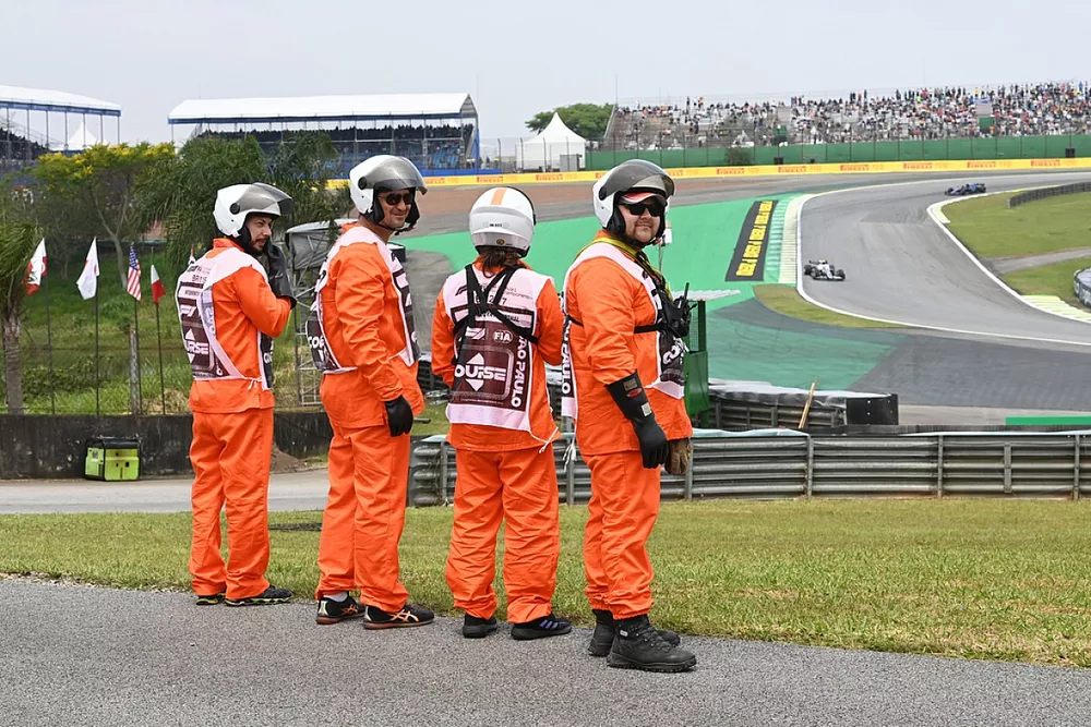 Marshals stand by as Yuki Tsunoda, AlphaTauri AT03, passes