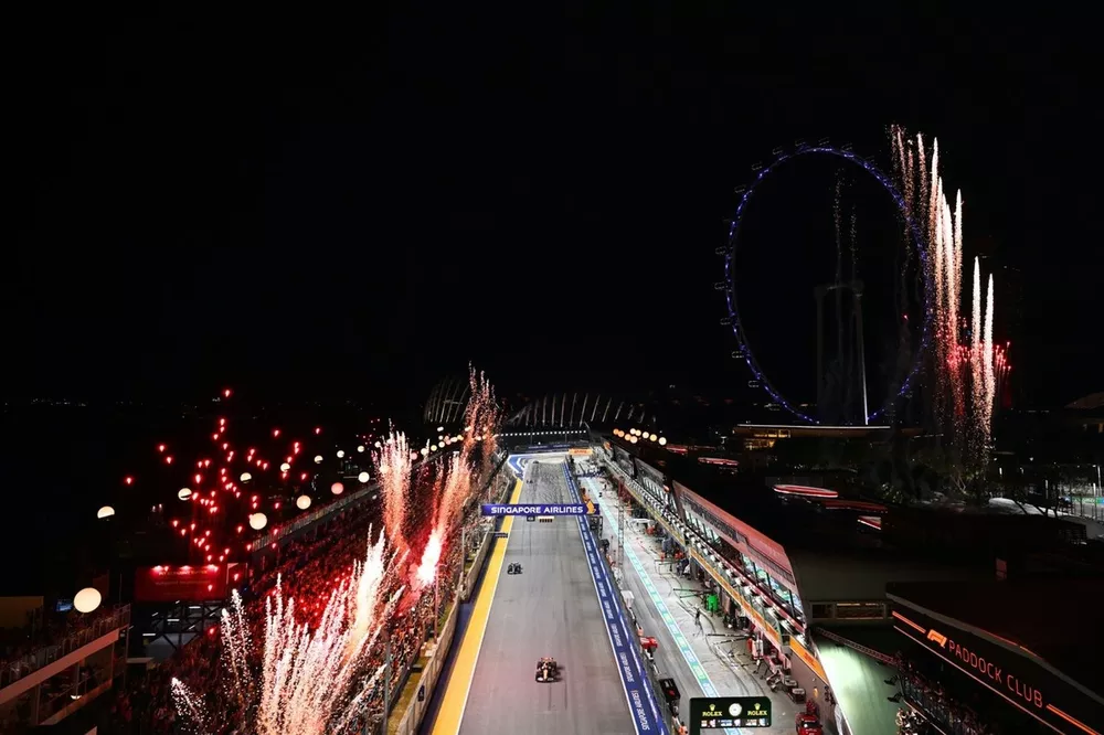 Fireworks light the sky at the end of the race as Oscar Piastri, McLaren MCL38, Fernando Alonso, Aston Martin AMR24, cross the line