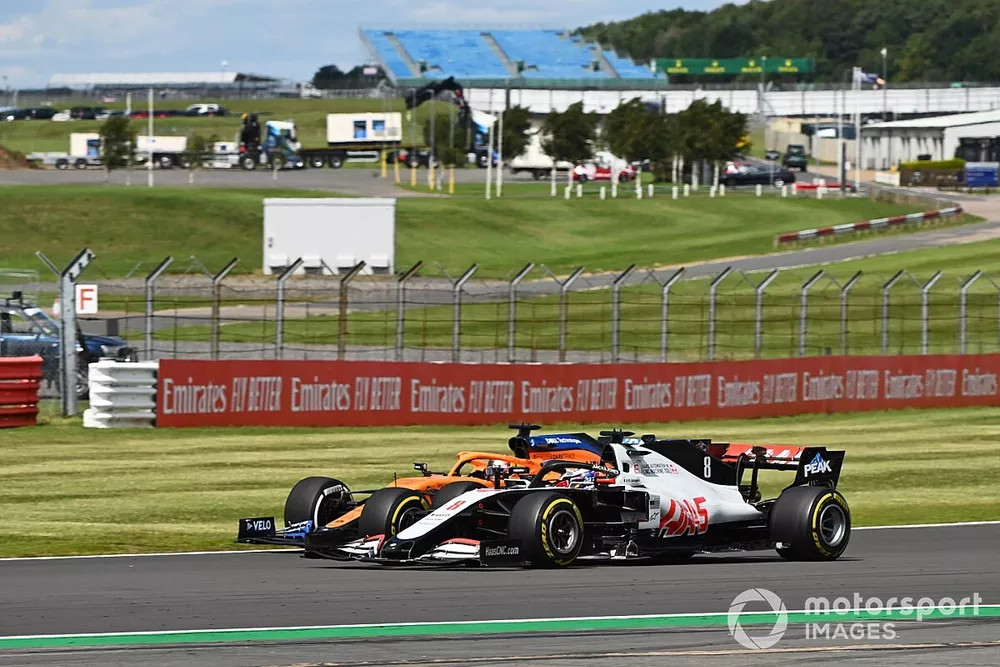 Romain Grosjean, Haas VF-20, battles with Carlos Sainz Jr., McLaren MCL35