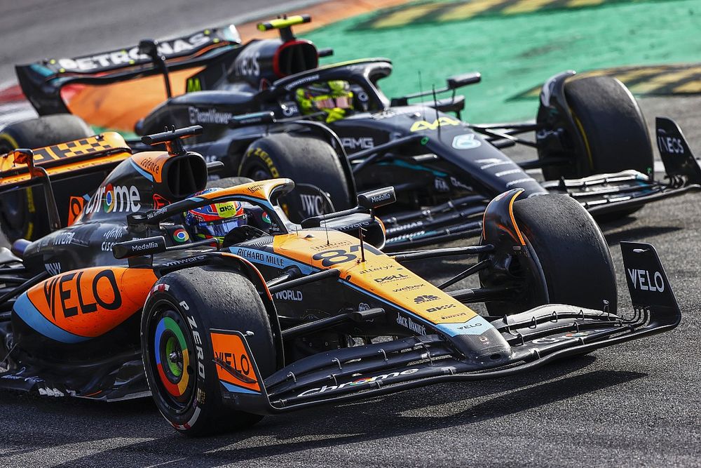 Oscar Piastri, McLaren MCL60, leads Sir Lewis Hamilton, Mercedes F1 W14