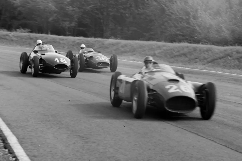 Peter Collins/Juan Manuel Fangio, Ferrari D50, leads Harry Schell, Vanwall, and Stirling Moss, Maserati 250F.