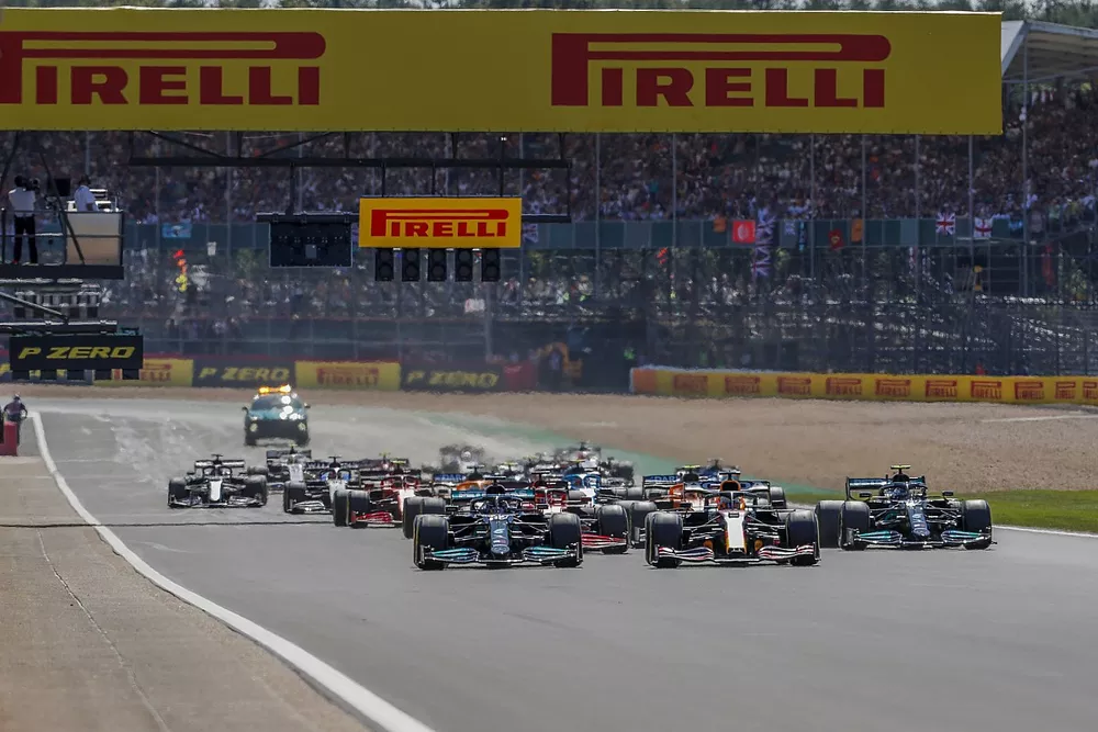 Max Verstappen, Red Bull Racing RB16B, and Lewis Hamilton, Mercedes W12, lead the field away at the start