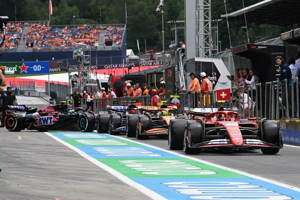 Carlos Sainz, Ferrari SF-24, Lando Norris, McLaren MCL38, Esteban Ocon, Alpine A524, in the queue to leave the pits